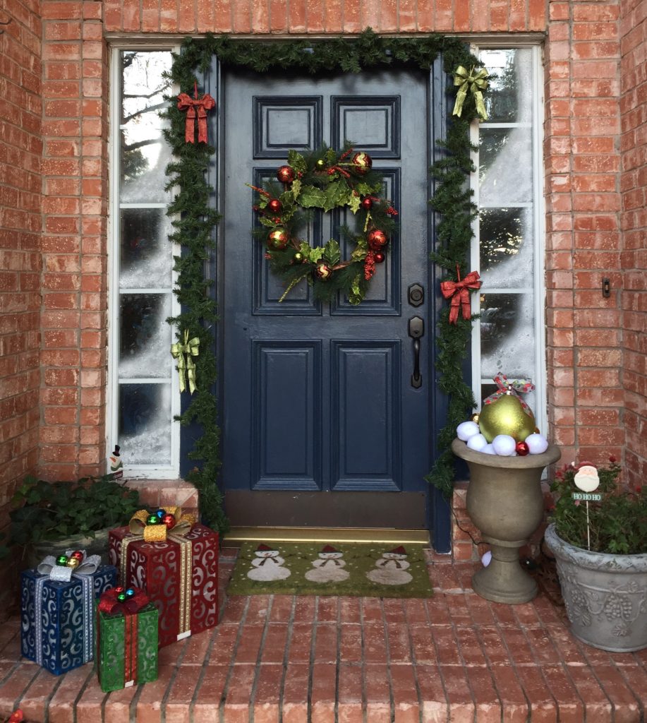 Christmas Entryway Ideas by Utah Interior Designer with gifts, garland, wreath, and door mat. 