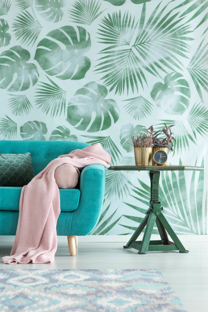 Bold Floral Wallpaper and brightly colored green sofa were big design trends in 2019
