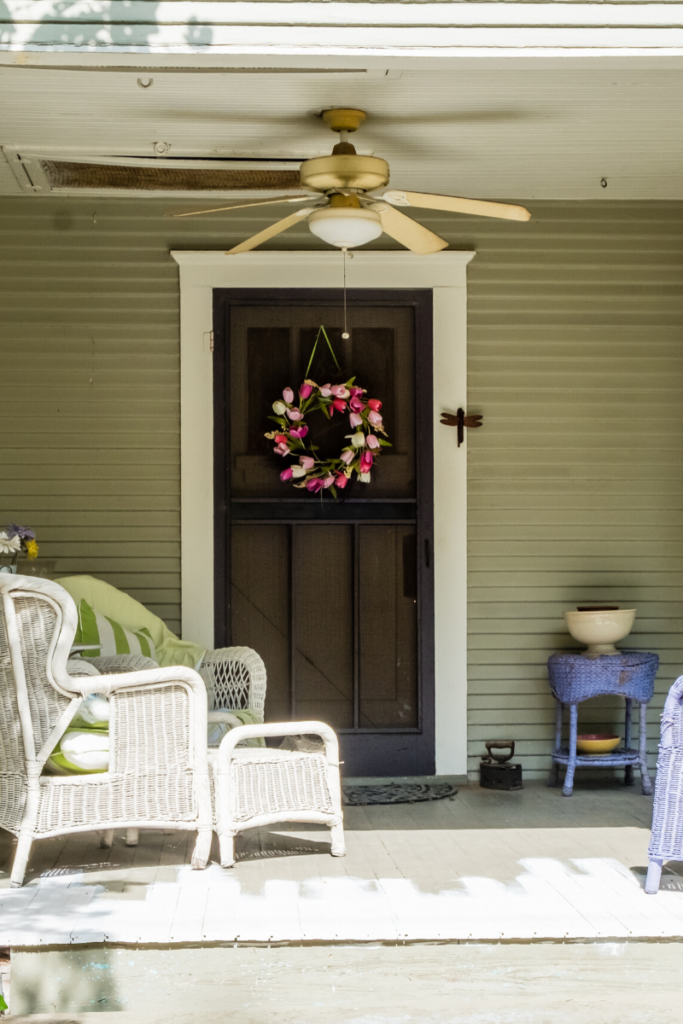HOme Staging Tips for the Front Door is add a colorful wreath and a welcoming chair. 