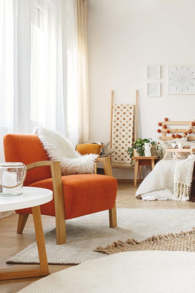 Orange Chair with furry blanket textiles in a room designed in 2019